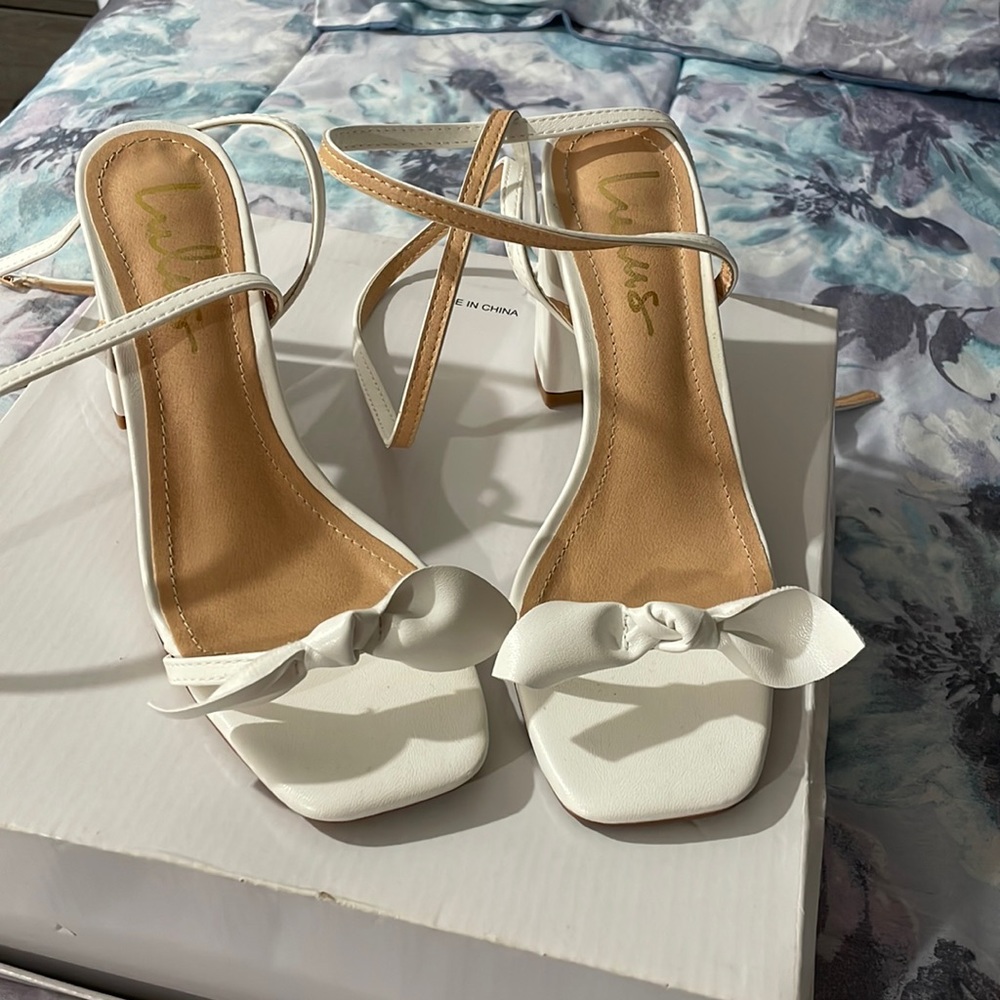 White laced up bow heels